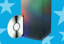 An Xbox Series X console with a disc sliding into the slot against a blue star background.