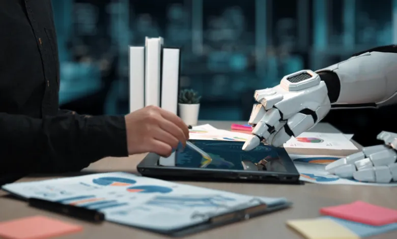 A human hand and a robotic hand working together on a digital tablet with financial charts.