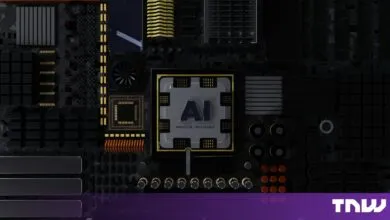 Close-up of a dark motherboard featuring a central chip stamped with the letters AI