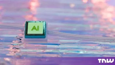 A green AI microchip connected to white cables rests on a reflective pastel surface.