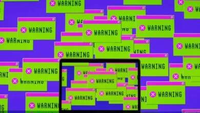 A laptop screen overflowing with dozens of bright green warning pop-up windows against a purple background.