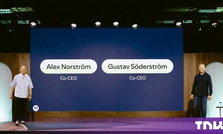 Spotify Co-CEOs Alex Norström and Gustav Söderström stand on stage below a large screen with their names.
