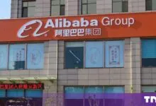Exterior storefront of an Alibaba Group office building featuring large white English and Chinese signage.