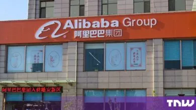 Exterior storefront of an Alibaba Group office building featuring large white English and Chinese signage.