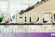 Illuminated white AMD corporate logo letters displayed in a bright modern lobby.