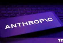 Smartphone displaying the white Anthropic logo against a purple background on a keyboard.