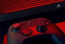 Atari VCS console and modern wireless joystick controller on a red background