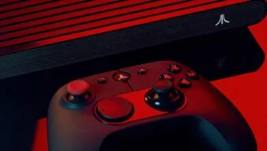 Atari VCS console and modern wireless joystick controller on a red background