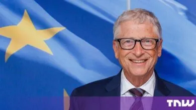Bill Gates smiling in front of the European Union flag in Brussels