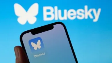 Smartphone displaying the Bluesky social media app with its butterfly logo against a blue background.