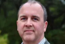 Portrait of automotive executive and engineer Doug Field looking directly at the camera.