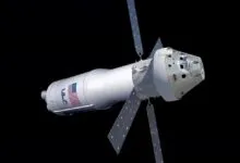 Boeing Starliner spacecraft with deployed solar panels in orbit against a black background.