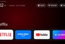 Smart TV home screen displaying time, date, settings, and streaming apps like Netflix
