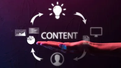 A hand holding glowing digital icons symbolizing content distribution and marketing strategy.