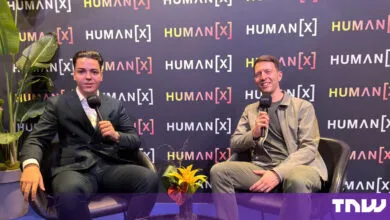 Cristian Dina and Job van der Voort posing with Rode microphones at HumanX Amsterdam
