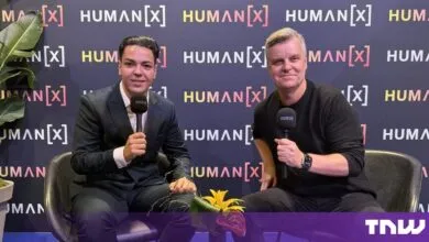 Cristian Dina and Tom Eggemeier holding microphones during an interview at HumanX Amsterdam.