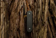 Black Electric Plant Co sensor mounted on rough tree bark with antenna