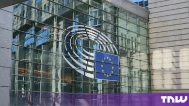 European Parliament logo and EU flag displayed on a modern glass building facade