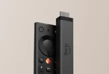 Amazon Fire TV Stick 4K and its remote control against a neutral background