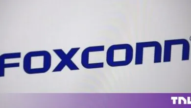 The dark blue Foxconn logo displayed centrally against a pale, softly lit background.
