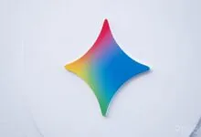 The colorful, four-pointed star Gemini logo mounted on a clean white wall background.