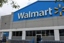 Exterior facade of a Walmart store with blue signage and shopping carts in front