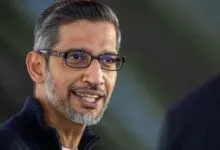 Close-up portrait of Google CEO Sundar Pichai smiling while wearing glasses.
