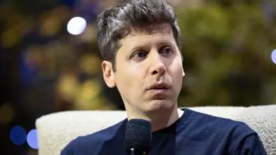 OpenAI CEO Sam Altman speaks into a microphone during an event or interview.