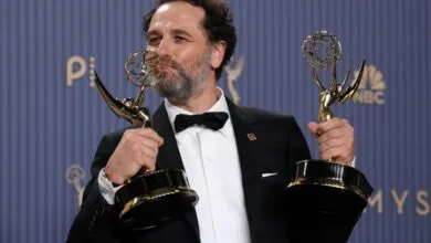Director and writer Justin Kurzel happily holds two golden Emmy statues.
