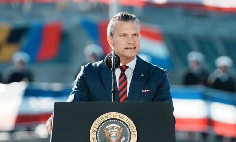 Pete Hegseth speaking behind a podium with the Presidential seal