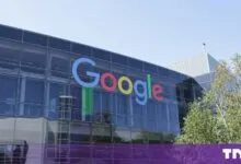 Modern glass-paneled Google headquarters building featuring the iconic colorful logo on the exterior facade.