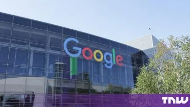 Modern glass-paneled Google headquarters building featuring the iconic colorful logo on the exterior facade.