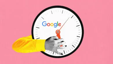 A person in a yellow sleeve holds the hands of a large wall clock featuring the Google logo.