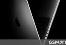 Close-up of a sleek space gray Apple MacBook showcasing its illuminated keyboard and iconic logo.