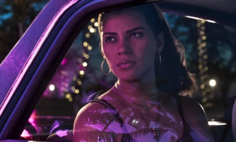 Lucia from GTA VI sitting in a car bathed in vibrant neon pink light.