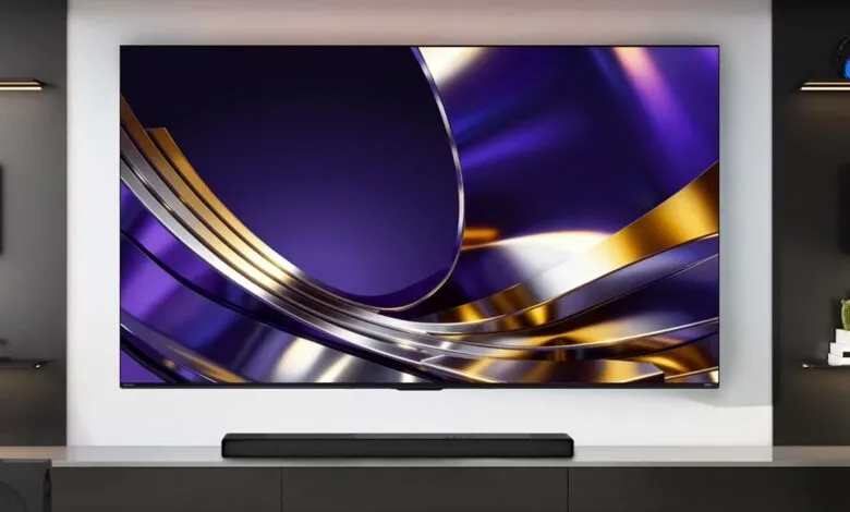 Large wall-mounted flat screen TV displaying a vibrant purple and gold abstract wallpaper in a modern living room