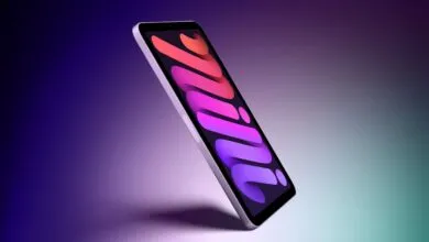 An angled view of an iPad mini floating against a gradient purple and teal background.