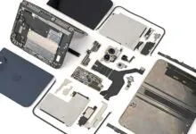 Disassembled smartphone parts laid out neatly on a clean white background.