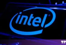 Glowing blue Intel logo displayed prominently on a smartphone screen in a dark environment
