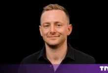 Headshot of Josh Payne, CEO of Nscale, smiling against a solid black background.