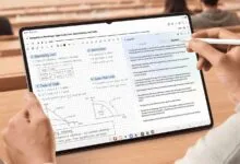 Student takes notes on a tablet with a stylus in a lecture hall.
