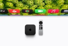 Apple TV 4K device and remote displayed below a TV screen showing colorful app icons.