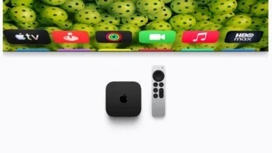 Apple TV 4K device and remote displayed below a TV screen showing colorful app icons.