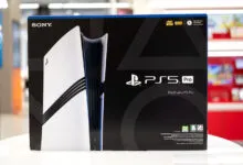 Close-up of the retail box for the Sony PlayStation 5 Pro gaming console on a white display table.