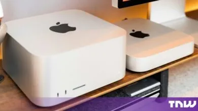 Apple Mac Studio and Mac Mac Mini sitting on a wooden desk side by side