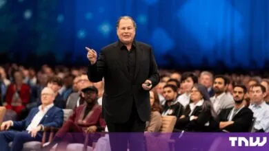 Marc Benioff speaking on stage at a large tech conference before an attentive audience
