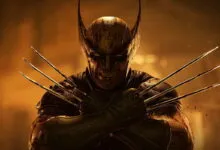 Wolverine crosses his arms with adamantium claws extended in a dramatic portrait.