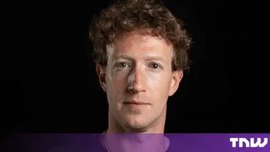 Close-up portrait of Meta CEO Mark Zuckerberg with curly hair against a black background.