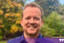 Portrait of Mike Howard, Whitespace CPO, smiling outdoors against a blurred green and yellow background.