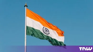 The Indian national flag waves proudly against a clear blue sky